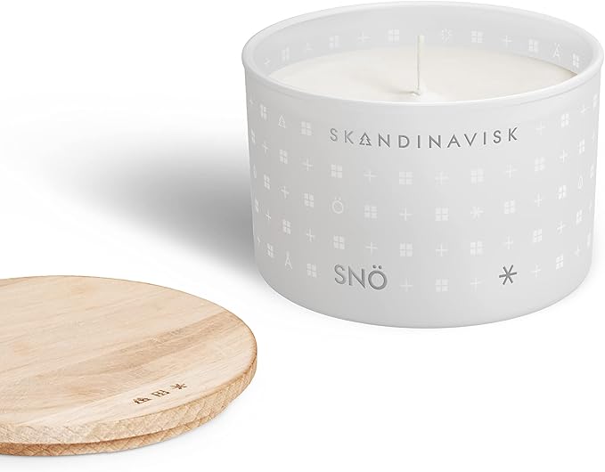Skandinavisk SNÖ 'Snow' Scented Candle. Fragrance Notes: Frozen Forests and Frosted Berries, The Sharp Breath of Subzero Skies. 3.17 oz.